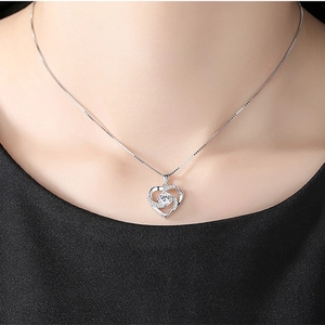 Elegant S925 silver heart necklace with a rotating sparkling zirconia pendant on a model