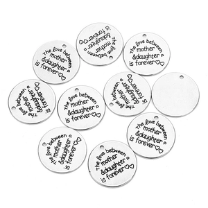 Macro view of polished silver engraved round charms for DIY necklace jewelry making