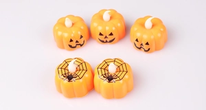 Set of five orange LED Halloween pumpkin lights with jack-o'-lantern and spider web patterns