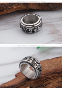 Macro detail of rotating stainless steel ring with embossed Sanskrit characters