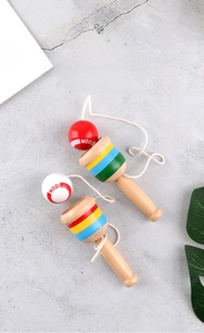 Close-up of wooden kendama skill toys with colorful striped cups and polished red and white balls