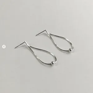 Detailed close-up of S925 sterling silver drop earrings with snake chain texture and bead