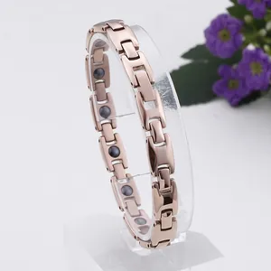 Bracelet magnétique élégant en titane rose doré pour femme sur un support transparent