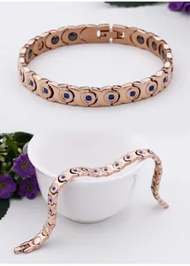 Detailed view of rose gold magnetic bracelet with blue crystals and black therapy magnets