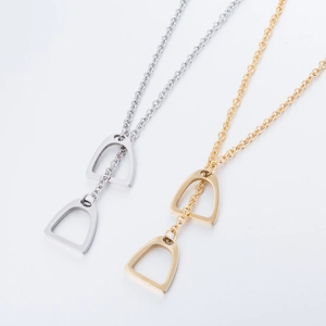 Minimalist stainless steel horseshoe necklaces in gold and silver finish on white background