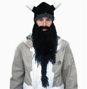 Detail of Viking knit hat with crochet horns and long black fringe beard accessory