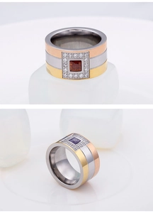Macro shot of tricolor titanium steel ring with central square purple gemstone and zircons