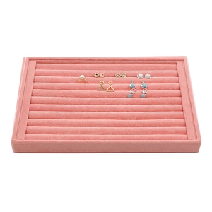Pink velvet jewelry display tray with multiple slots for rings and earrings storage