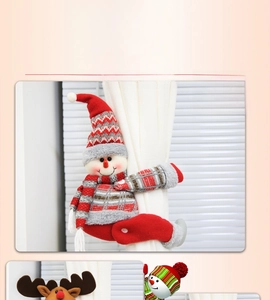 Detail of plush snowman and reindeer Christmas curtain buckles on fabric curtains