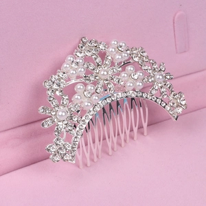 Detail of silver bridal hair comb with pearls and rhinestones in flower design