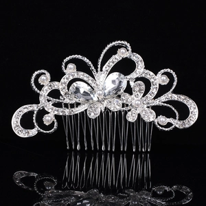 Silver bridal hair comb with pearls and rhinestones shown on a reflective black background