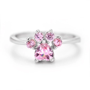 Close-up of cute cat paw ring featuring a heart-shaped pink zircon and silver plating
