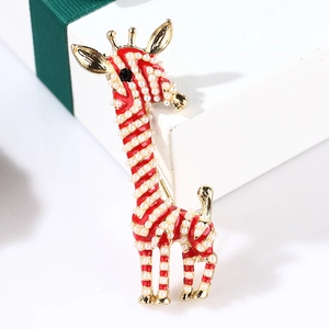 Close-up of giraffe brooch with red enamel stripes and faux pearls on gold alloy