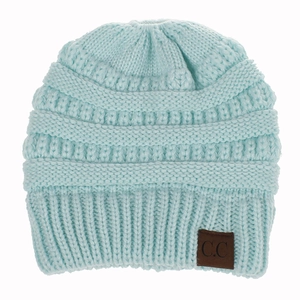 Close-up of light blue chunky knit beanie with a brown C.C brand leather patch detail