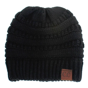 Close-up of black cable knit beanie with thick texture and brown C.C leather patch