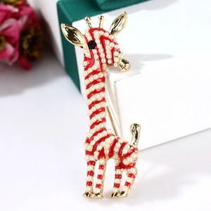 Detail of giraffe brooch with red enamel stripes and pearl inlays on gold metal