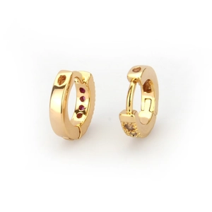 Detail of 18k gold plated hoop earrings featuring sparkling red zircon gemstones