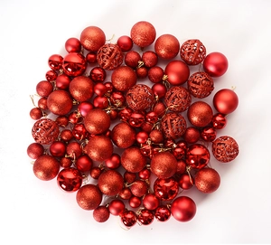 Flat lay of red Christmas balls in shiny, matte, glittery, and hollow textures