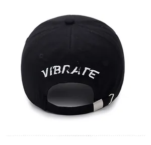 Detail of black cotton baseball cap back with white VIBRATE embroidery and metal buckle