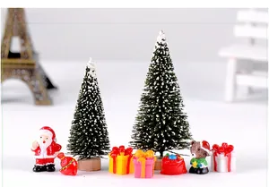 Miniature Christmas landscape set with snow-dusted trees, Santa, and colorful gift boxes