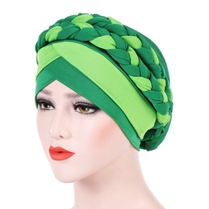 Detail of the green braided turban with soft knitted fabric and multi-color weaving design