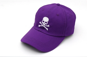 Detailed close-up of a purple cotton baseball cap featuring white skull embroidery