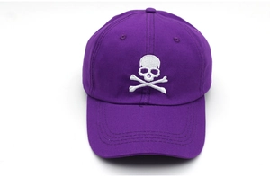 Close-up of white skull embroidery on a premium purple cotton baseball cap for adults