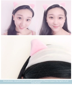 Detail of soft plush cat ear headband in pink and beige for skincare and makeup