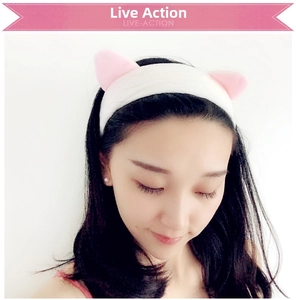 Detail of soft plush cat ear headband for washing face and makeup in white and pink