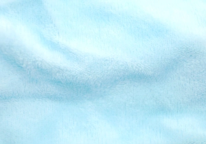 Close-up detail of soft light blue plush fabric with fluffy texture for hair bands