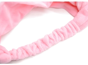 Detailed close-up of the elastic band structure on a pink plush cat ear headband