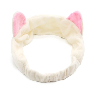 Detail of soft plush off-white headband featuring cute pink cat ears for skincare