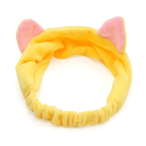 Detail of yellow plush cat ear headband with soft pink interior and elastic band design