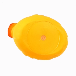 Detail view of the yellow rubber duck bottom showing the orange squeaker and material