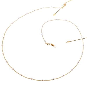 Elegant gold pearl eyeglasses chain with white pearls on white background for glasses