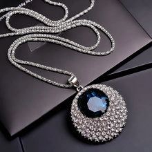 Macro view of blue crystal butterfly pendant necklace with shimmering silver accents