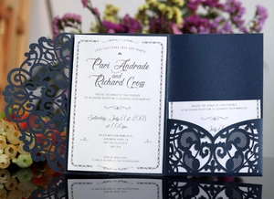 Detailed laser cut navy blue wedding invitation suite with elegant floral patterns
