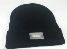 Detail view of a black knitted beanie with a built-in LED light and 4 bright LED beads