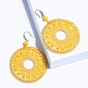Vibrant yellow beaded hoop earrings featuring a woven design and silver metal hooks