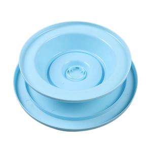 Detail view of the rotating mechanism on a light blue plastic cake decorating turntable