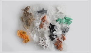 Close-up of individually bagged plastic animal building block models including tigers and sharks