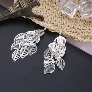 Detail of silver multi-layered hollow leaf drop earrings with sleek metallic finish
