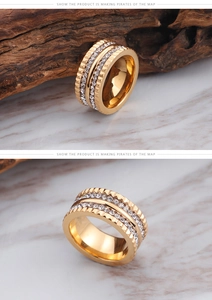 Detailed macro view of wide gold band ring with double rows of white cubic zirconia