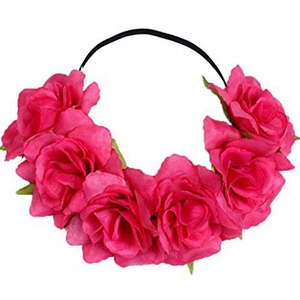 Detailed view of pink fabric rose floral headband with black elastic band on white background