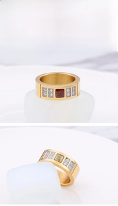 Detail of a gold titanium ring featuring a square gemstone and paved side zircon stones