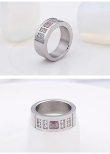 Detailed macro view showing the square clear and pink gems on wide titanium ring