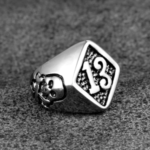 Detailed close-up of a punk skull ring featuring an embossed number 13 on a shield