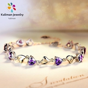 Close-up of S925 silver bracelet featuring purple heart-shaped gemstones and hollow hearts