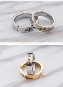 Detail view of gold and silver stainless steel rings with 'MY LOVE' engraving and zircon