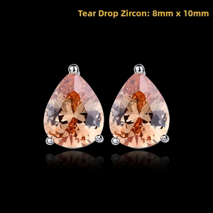 Macro shot of water-drop champagne zircon earrings with silver settings on black background